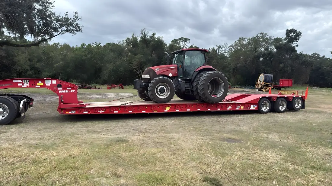 Case tractor on a gooseneck trailer