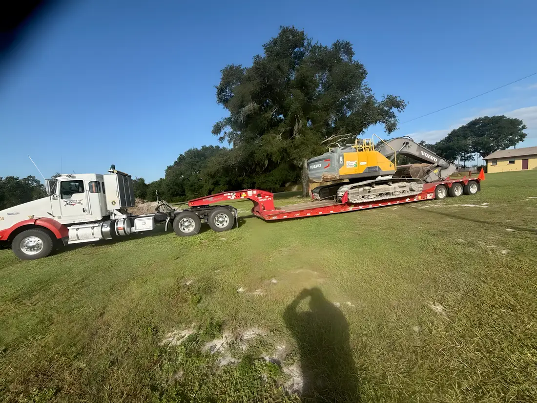 Tracked excavator on a lowboy trailer