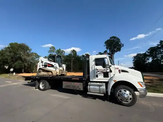 Construction equipment transport — skid steer ready to haul