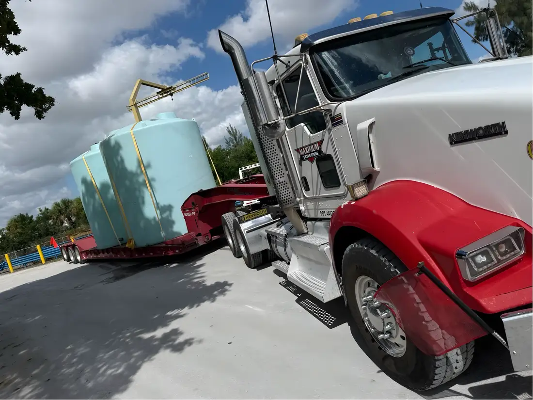 Oversized tank secured on a lowboy trailer